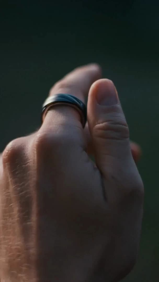 Glorify Ring worn in a quiet moment among palm leaves